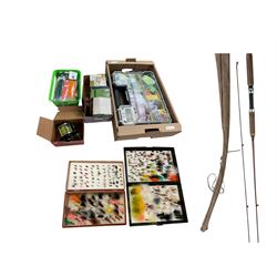 Two boxes of assorted fly fishing flies together with can fishing rod and other fishing tackle