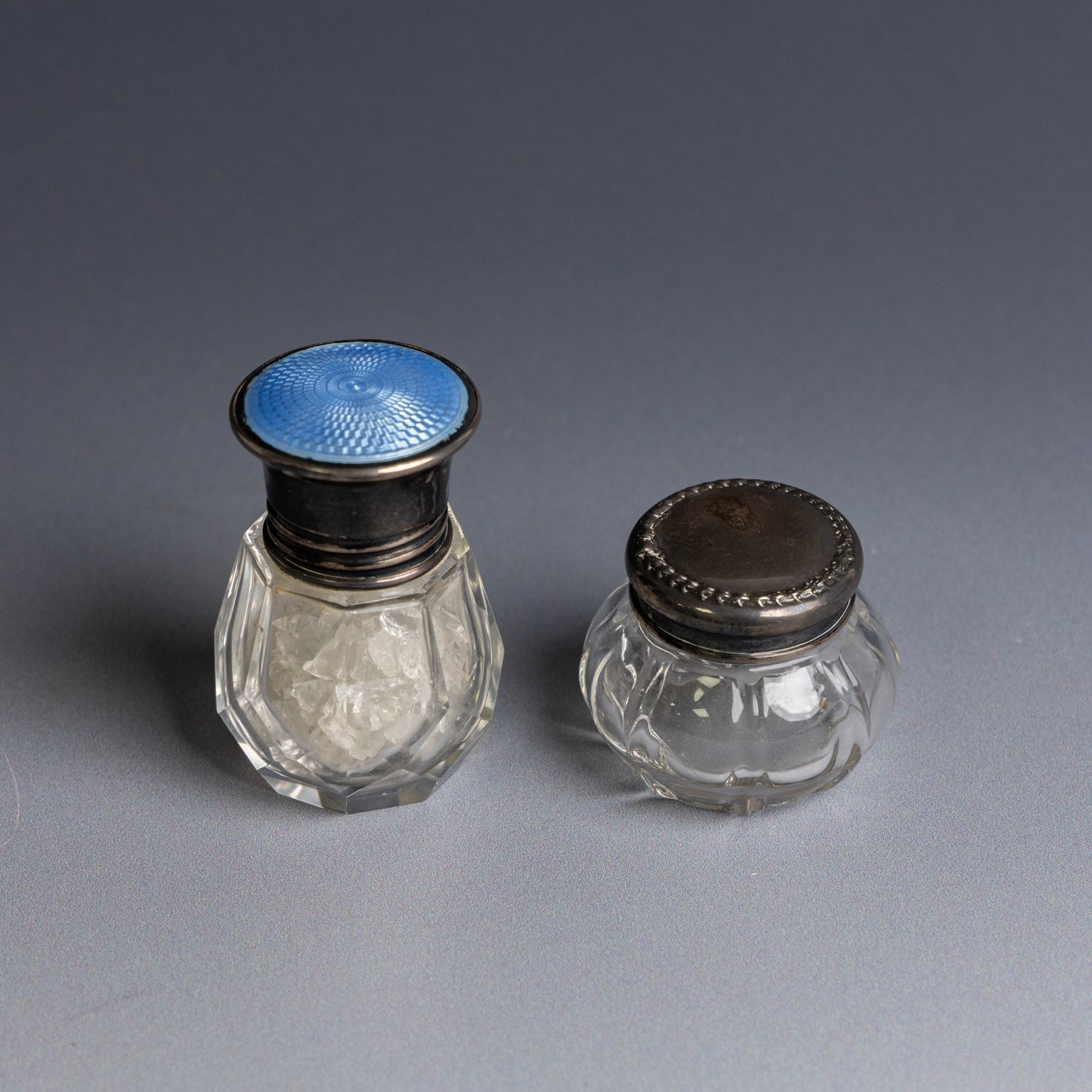 Victorian silver inkwell stand, with silver topped inkwell, hallmarked Lawrence Emanuel, Birmingham 1893, together with a mother of pearl dip pen with silver collar and two silver topped jars, one with guilloche enamel decoration, all hallmarked