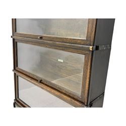 Globe Wernicke - stacking sectional library bookcase, over four glazed up-and-over doors, each bearing original makers mark, on moulded plinth base with inbuilt drawer