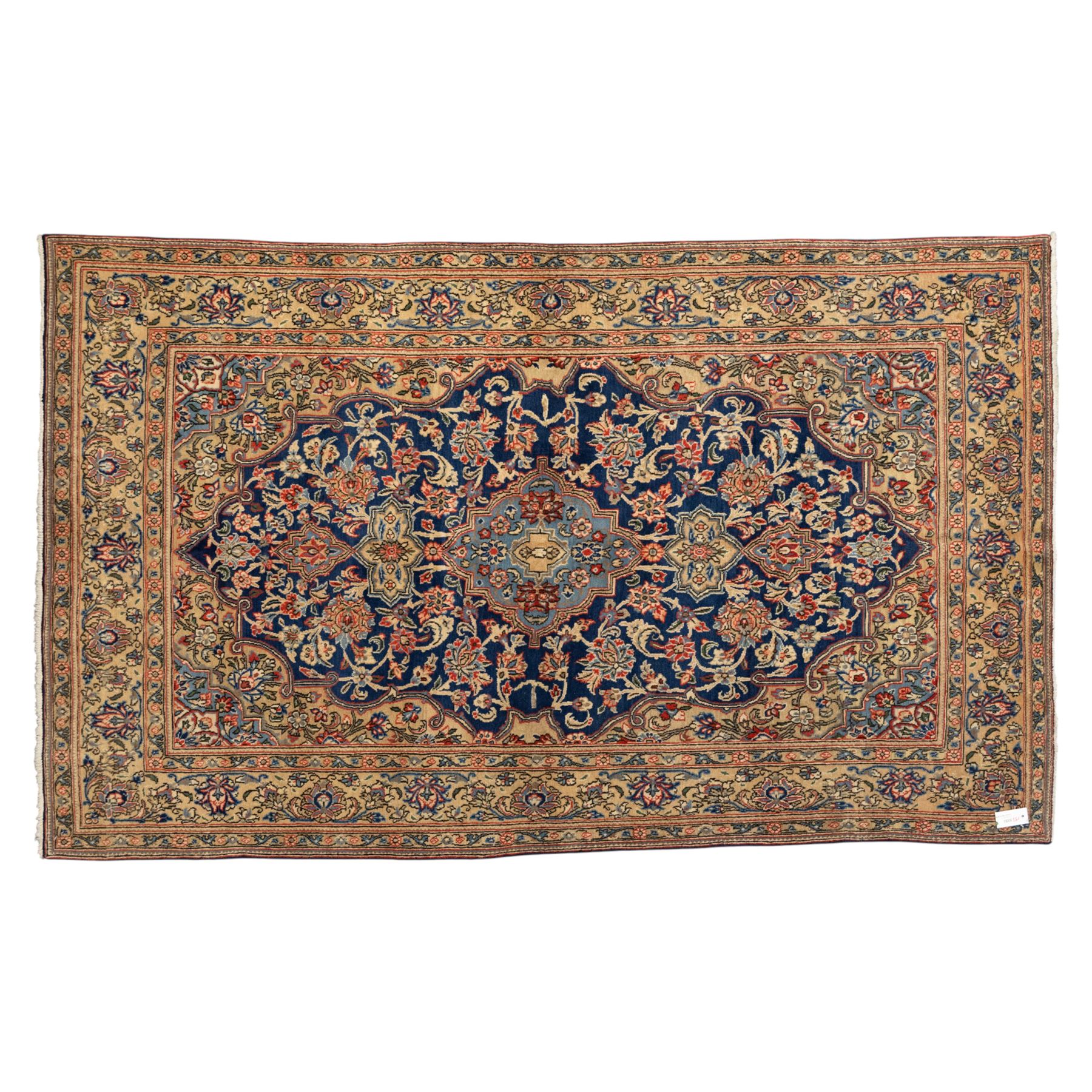 Persian Kashan rug, navy field with lobed central medallion and scrolling floral sprays, ivory spandrels within a palmette and vine border