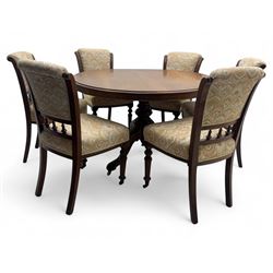 Victorian mahogany centre table, circular top above turned pedestal, terminating on three cabriole legs with scroll feet on porcelain castors, and six scroll carved upholstered dining chairs, with cushion and spindle turned backs, centre table  118x74cm, dining chairs 89x46x50cm