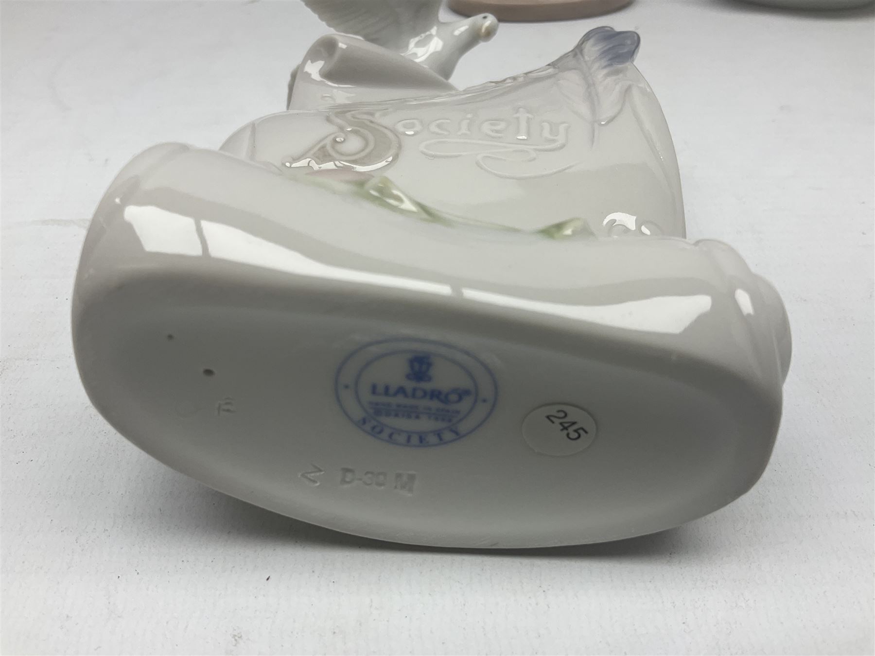 Three Lladro figures, comprising Dear Santa no 6166, Angelic Melody 1993 no 5963 and Seraphs Head no2 no 4885, together with Lladro plaque Love Brings Us Together no 7677, all with original boxes, largest example H18cm