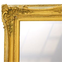 French style gilt composition wall mirror, the rectangular plate within a swept frame moulded with scrolling foliage and shell motifs