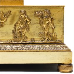 Empire period-gilt brass early 19th century French figural mantel clock c1820, the case surmounted with a figure of Ceres the Roman goddess of plenty holding a cornucopia overflowing with fruit and corn, supported on a rectangular plinth base with depictions of putti representing the arts and labour, movement case with floral garlands and a leaf and ribbon dial bezel, convex white enamel dial with moon hands and short Roman numerals, with a  Parisian 8-day twin-train countwheel striking movement and silk suspension, striking the hours and half-hours on a bell.
With pendulum and key. 