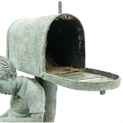 After Eneri Prosperi, bronze garden letterbox, modelled as a seated boy reading on a tree stump, with rustic post box with mail indicator, dog at his feet, textured verdigris finish throughout