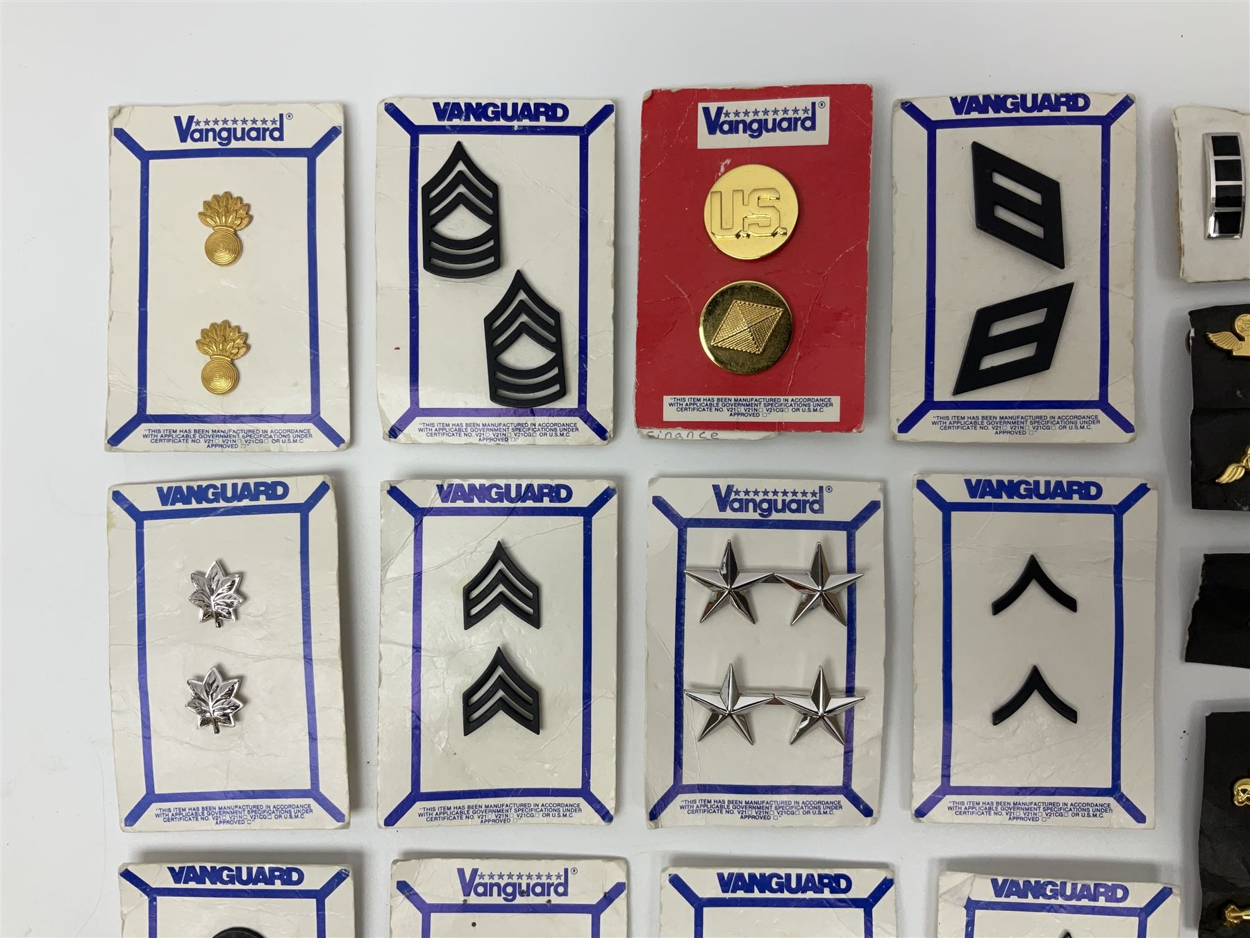 Fifty US rank badges and trade badges; WW2 and Vietnam period; predominantly on sale cards