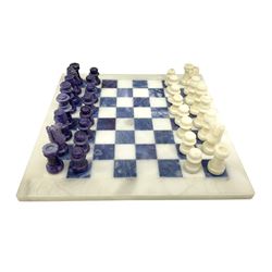 Polished hardstone chess board, with alabaster and charoite pieces 