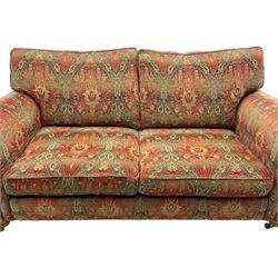 Duresta - 'Beaminster' grande two-seat sofa, traditional shape with rolled arms, upholstered in 'Althorp' russet and stone floral pattern fabric, on turned feet with brass castors
