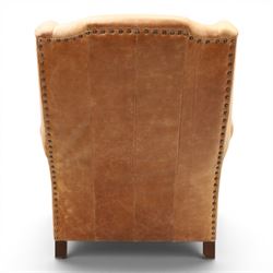 TETRAD for John Lewis - brown leather upholstered wingback armchair, button back with diamond tufted detail, loose seat cushion with piped edge, scroll arms and padded side wings, on short supports