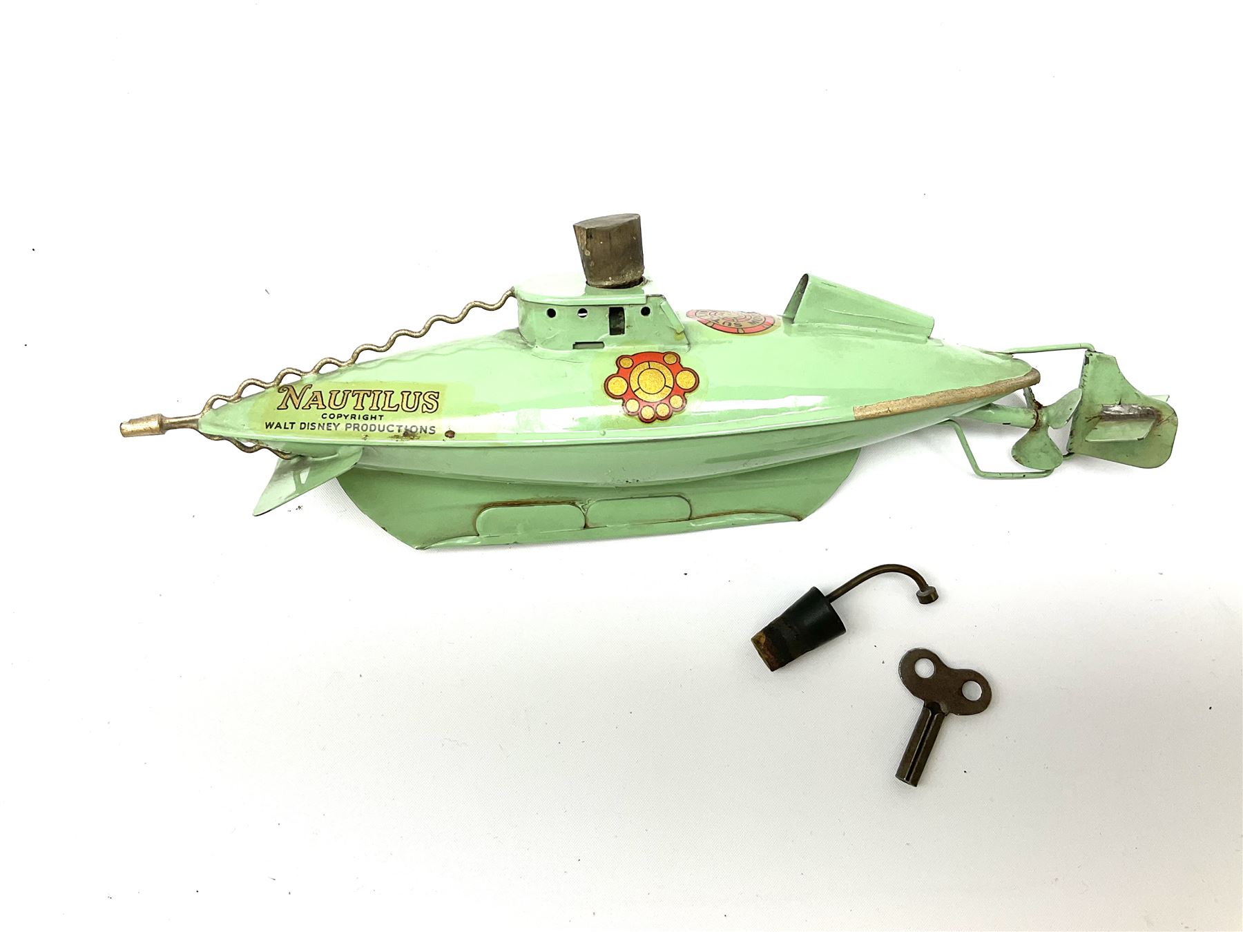 Sutcliffe Models ‘Nautilus’ tinplate and clockwork submarine from Walt Disney’s ’20,000 Leagues Under The Sea’ by Jules Verne, sea green body with various decals, rubber bung with periscope, boxed with inner cardboard display piece, produced between 1955-1960