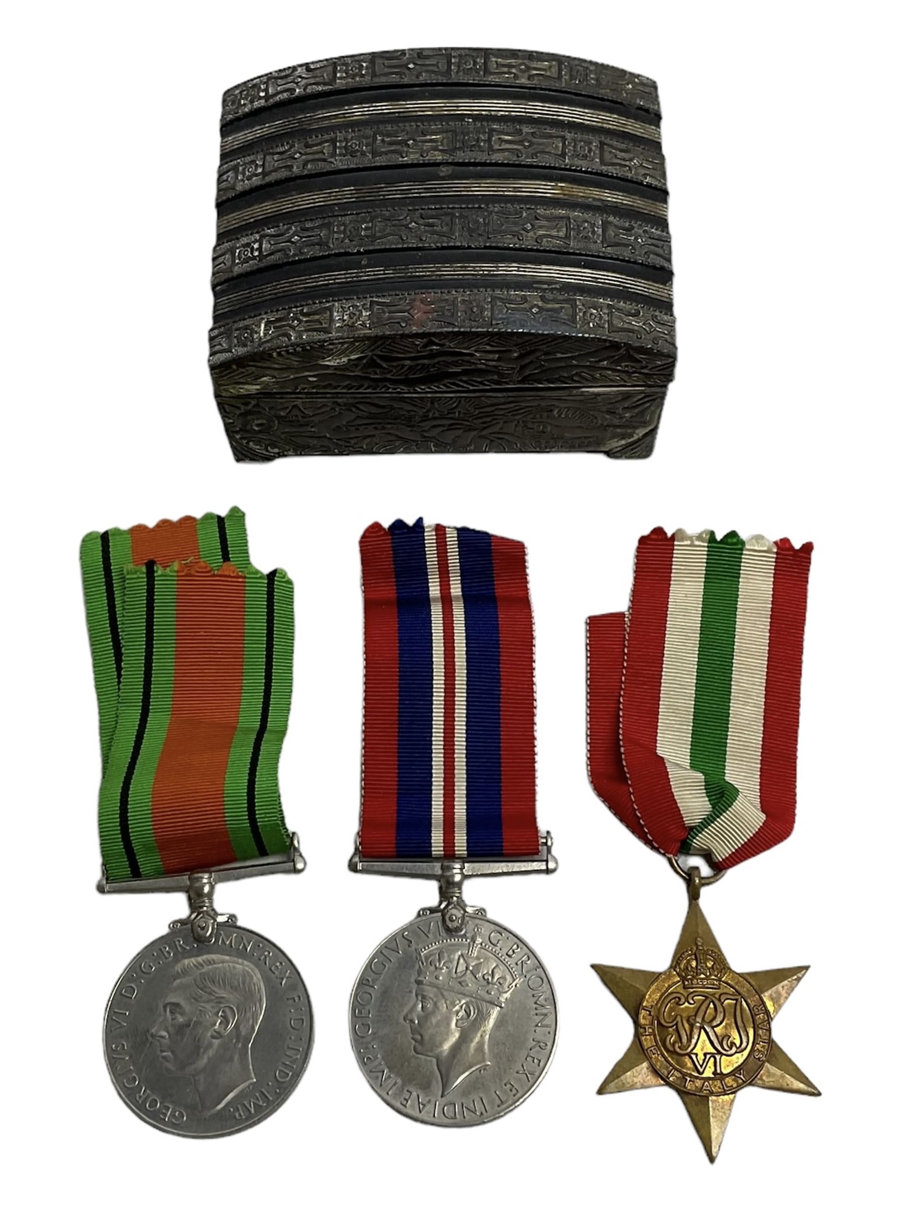 WWII service medal trio comprising Defence Medal, 1939-1945 medal and 1939-1945 Star, with various ribbons and box