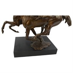 Bernard Winskill  (d1980) - 'Upsides on High Moor' a bronze group of two horses and riders, signed, on wooden base 45cm x 48cm