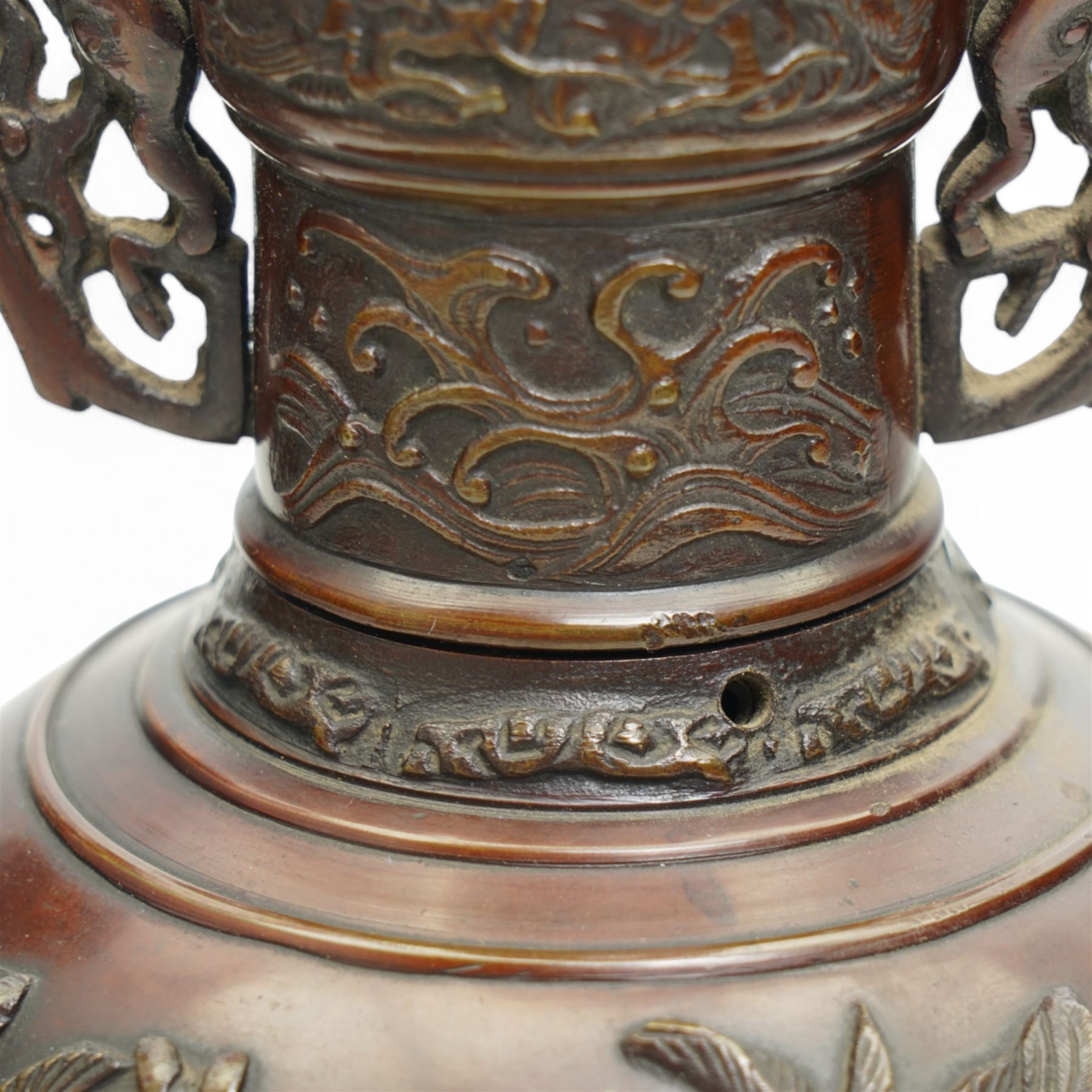 Pair of Japanese two-handled bronze vases, of baluster form with elongated neck, decorated with a raised pattern of birds and flowers, H26cm (2)