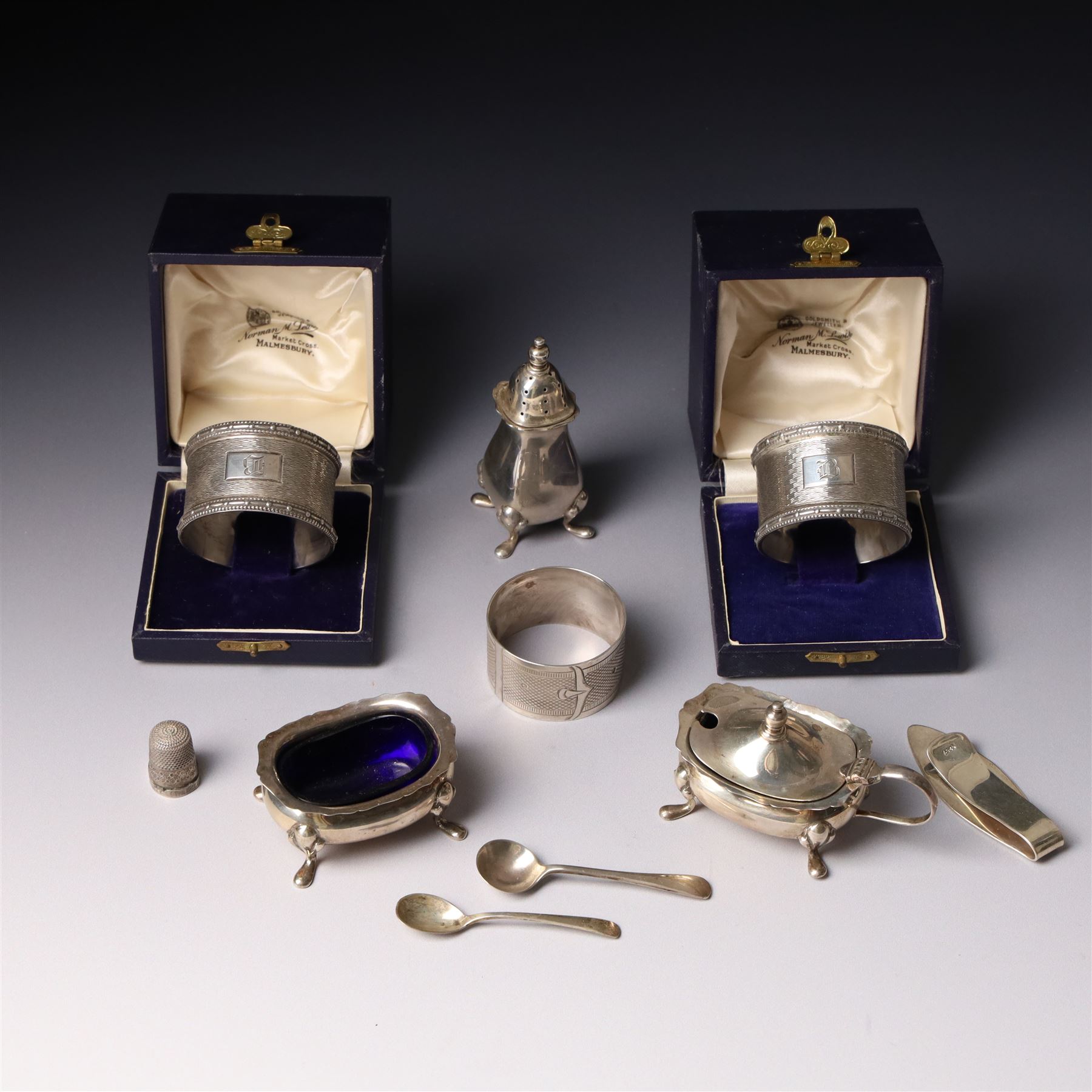 Silver three piece condiment set Birmingham 1938, pair of silver napkin rings, cased, plated napkin ring, silver money clip and silver thimble