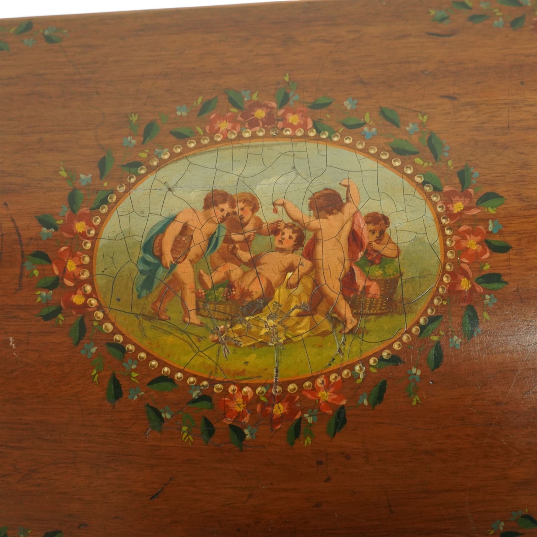 Edwardian painted mahogany and satinwood music cabinet, of rectangular form with domed hinged lid, the front and top decorated with hand-painted floral garlands and a central neoclassical panel depicting cherubs, raised on square tapering legs with gilt highlights