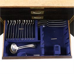 Ealy 20th century oak canteen, with five drawers behind double doors, four drawers containing a part set of silver plated Hanoverian pattern cutlery with engraved monograms and a set of twelve mother of pearl handled fruit knives and forks, the last drawer containing a collection of loose silver plated cutlery, canteen H39cm, W48cm