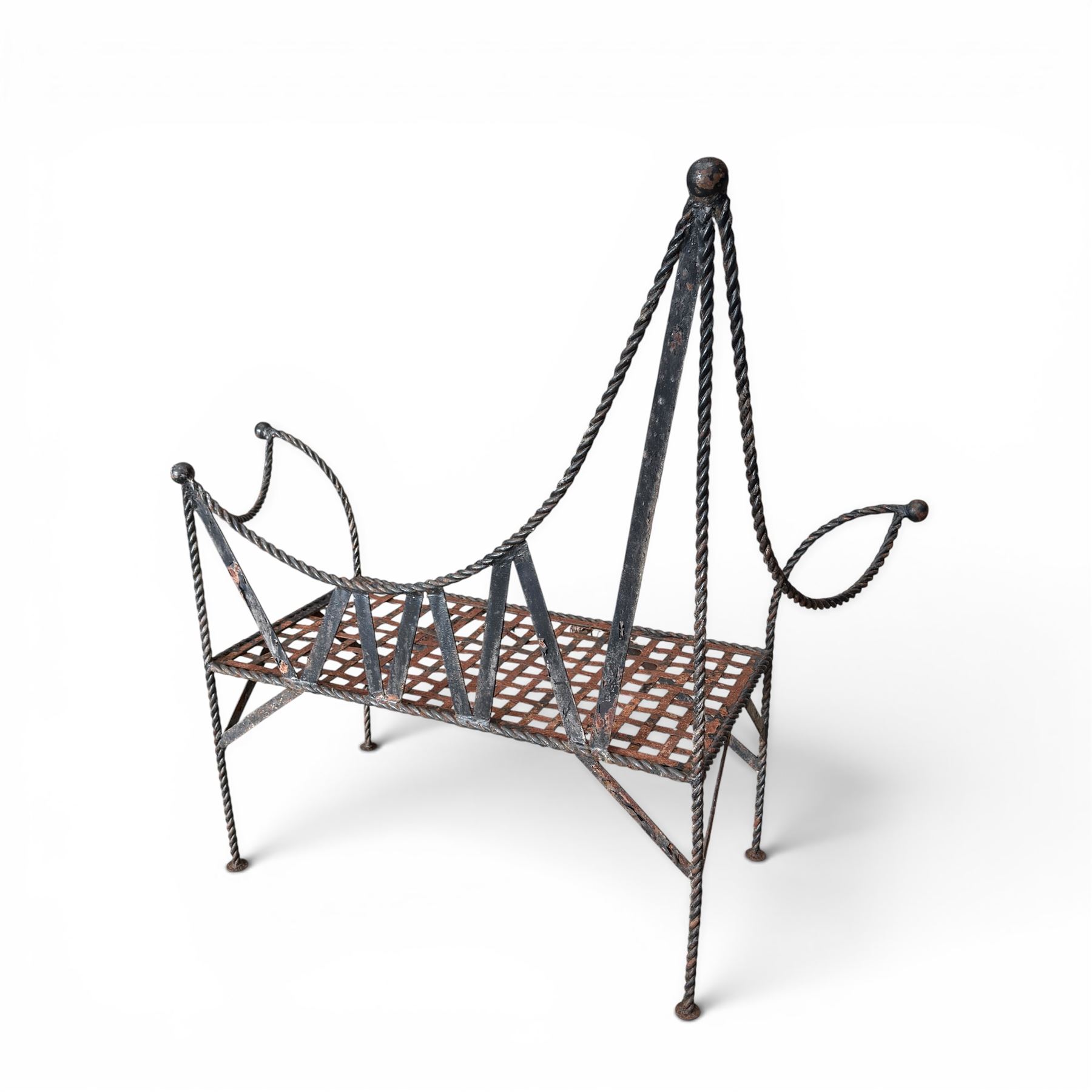 Victorian design wrought iron garden bench, with asymmetrical rope-twist frame, arched back and sides over out-swept arm terminals with ball finials, flanking a lattice seat, in antique black-painted weathered finish