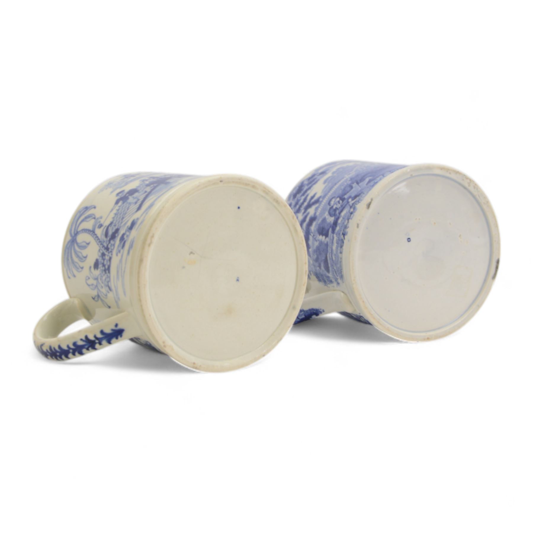 Two large 19th century blue and white transfer decorated pearlware mugs, the first example depicting a Chinese landscape with pagoda, and figures at rest and play, the second a pastoral landscape with shepherd and goats by waters edge, each approximately H12.5cm