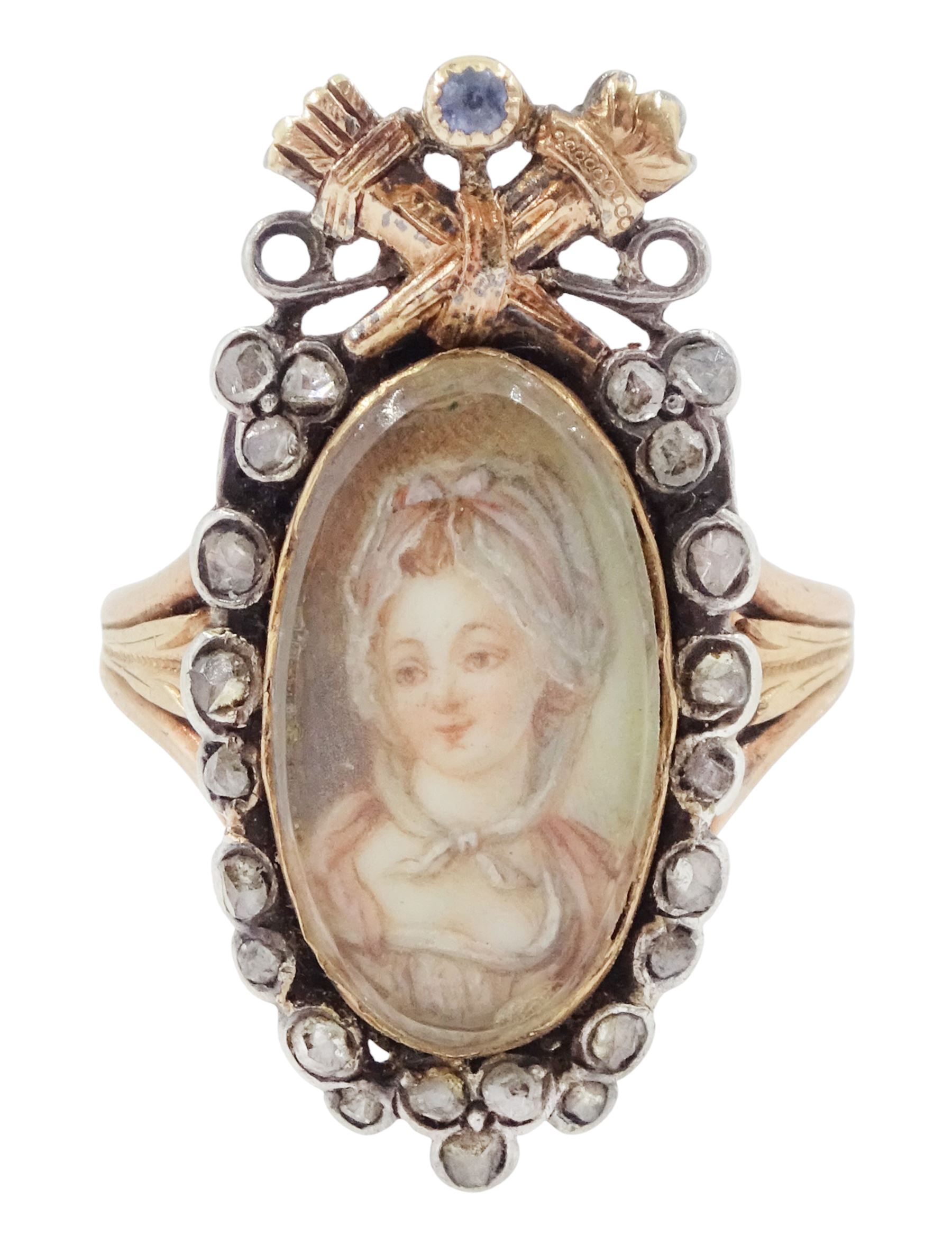 18th / 19th century silver and gold diamond and sapphire portrait ring, set with an oval miniature of a woman wearing a bonnet on ivory, under a glazed panel, surmounted with a 'trophy of love' symbol, modelled as a flaming torch and bow and quiver, set with a single round cut sapphire and rose cut diamond surround, to trifurcated shoulders, on French 18ct gold shank, Eagle hallmark. This lot has been registered for sale under Section 10 of the APHA Ivory Act