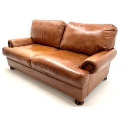 Three seat studded tan leather sofa, scrolling arms, turned supports (W190cm) with matching two seat (W155cm) armchair (W100cm) and footstool 