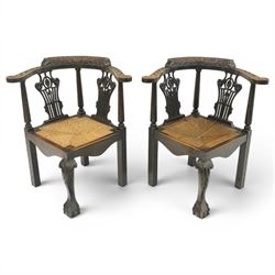 Pair of 19th century carved oak corner chairs, cresting rail carved with central floral bo...