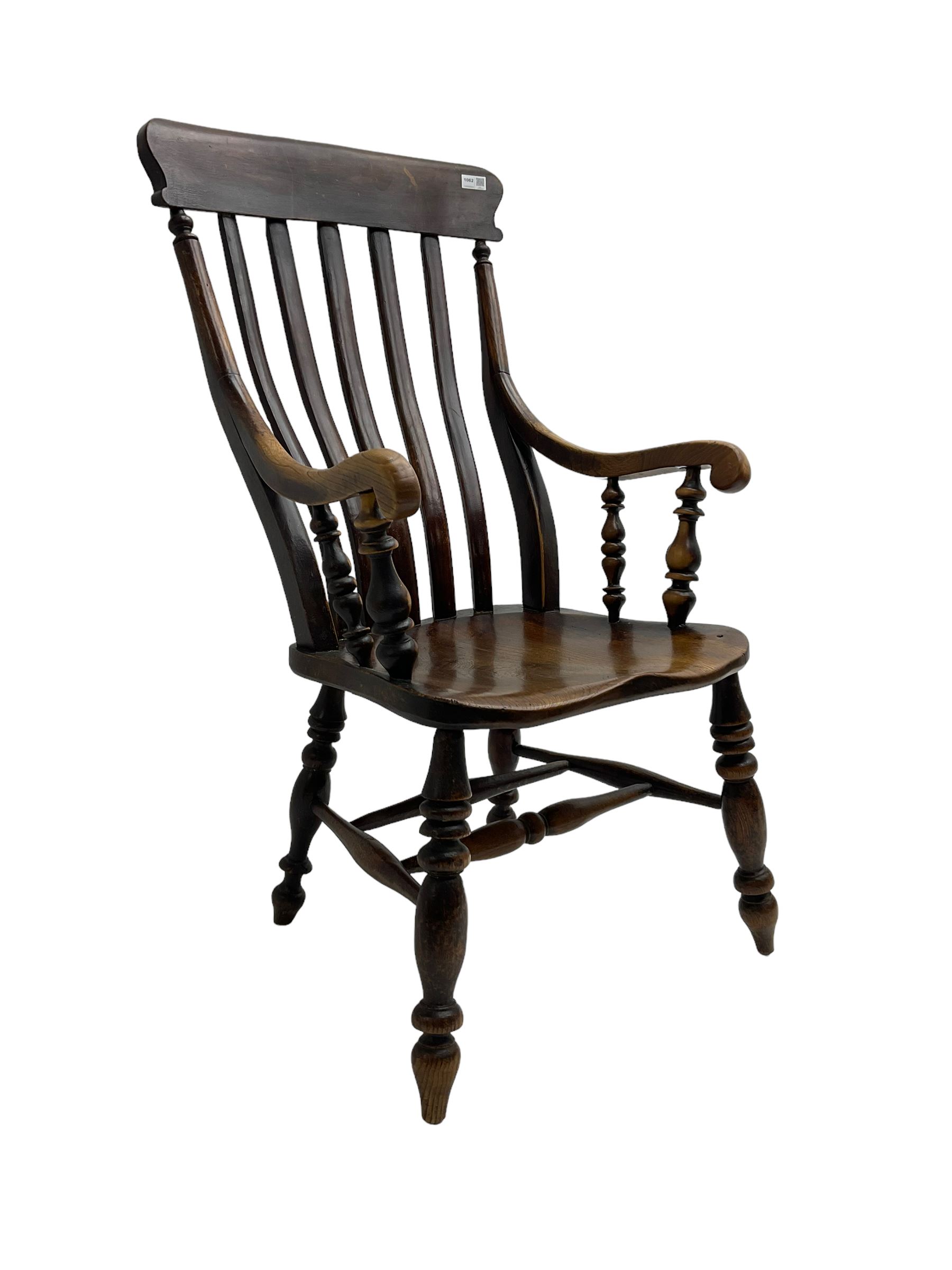 Late 19th century elm farmhouse armchair, high lath back raised on turned supports united by stretcher