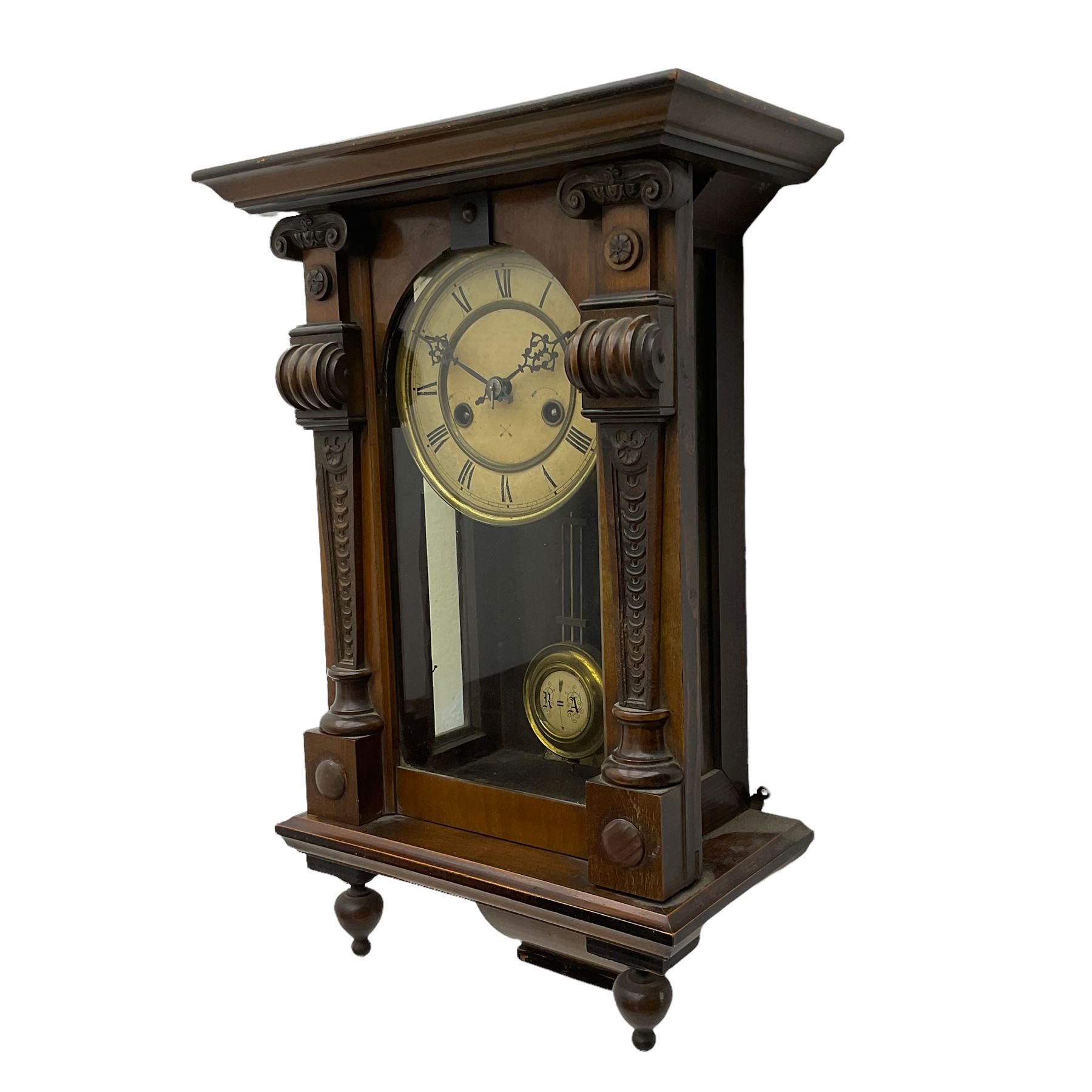 A German HAC wall clock with an eight-day spring driven movement, striking the hours on a gong, with a two-part ivorine dial and pierced gothic hands, gridiron pendulum with beat plate. 

