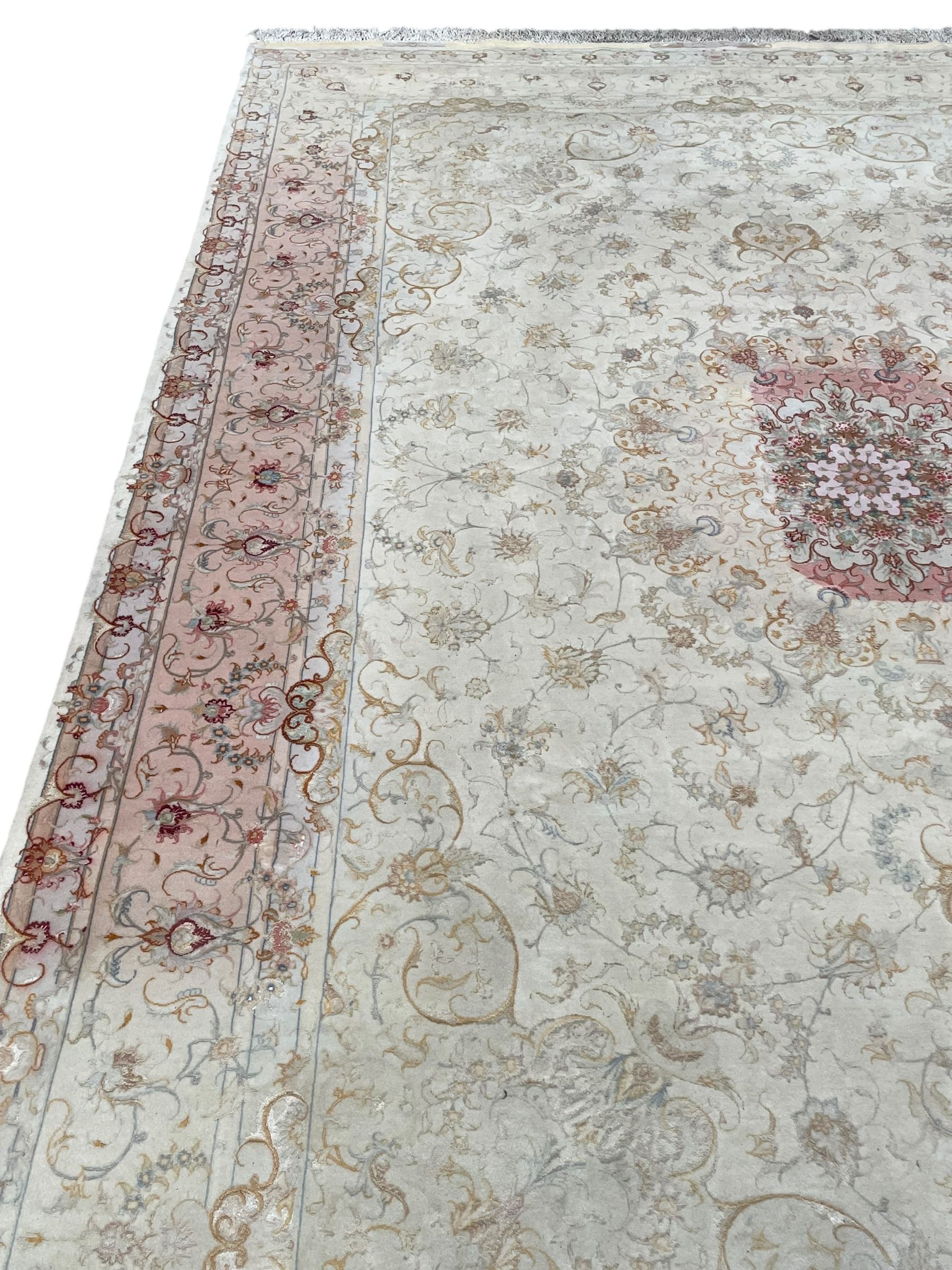 Persian Mahal densely knotted ivory ground carpet, floral rosette medallion surrounded by interlacing leafy branches and palmettes, scrolling border decorated with foliate motifs, within guard stripes, with signature panels to each end