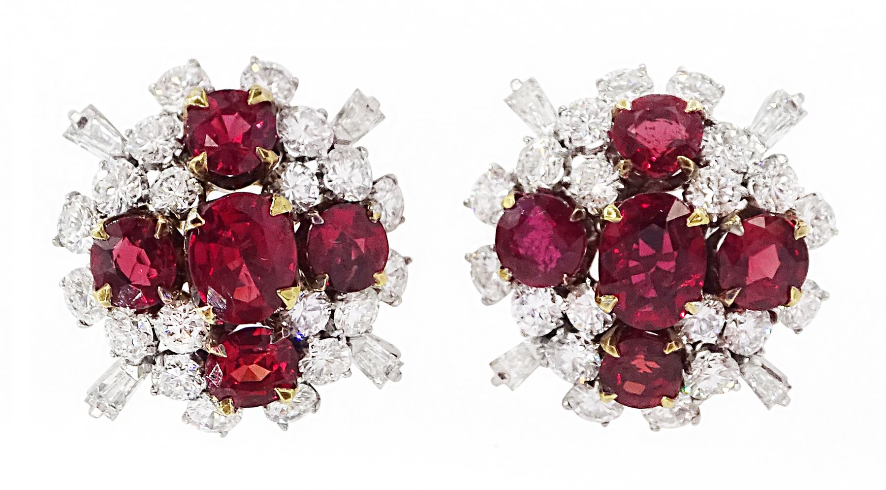Pair of 18ct white and yellow gold Burmese ruby and diamond stud earrings, each cluster with five oval and round cut rubies and round brilliant cut and tapered baguette cut diamonds, total ruby weight approx 3.40 carat, total diamond weight approx 2.25 carat, in fitted box by Licht & Morrison, London
