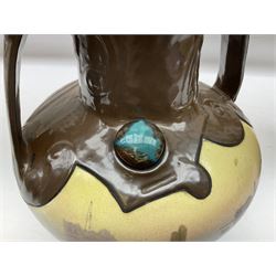 T. Forester Phoenix ware ewer of tapering form decorated with peacock and Bretby twin handled vase decorated with figures fishing in a boat sea scene