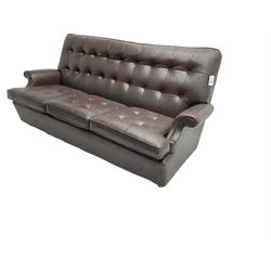 Parker Knoll - modernist three seater sofa, upholstered in button back chocolate leather, on castors (W193cm D95cm H85cm); and matching reclining armchair (W80cm D85cm H93cm)