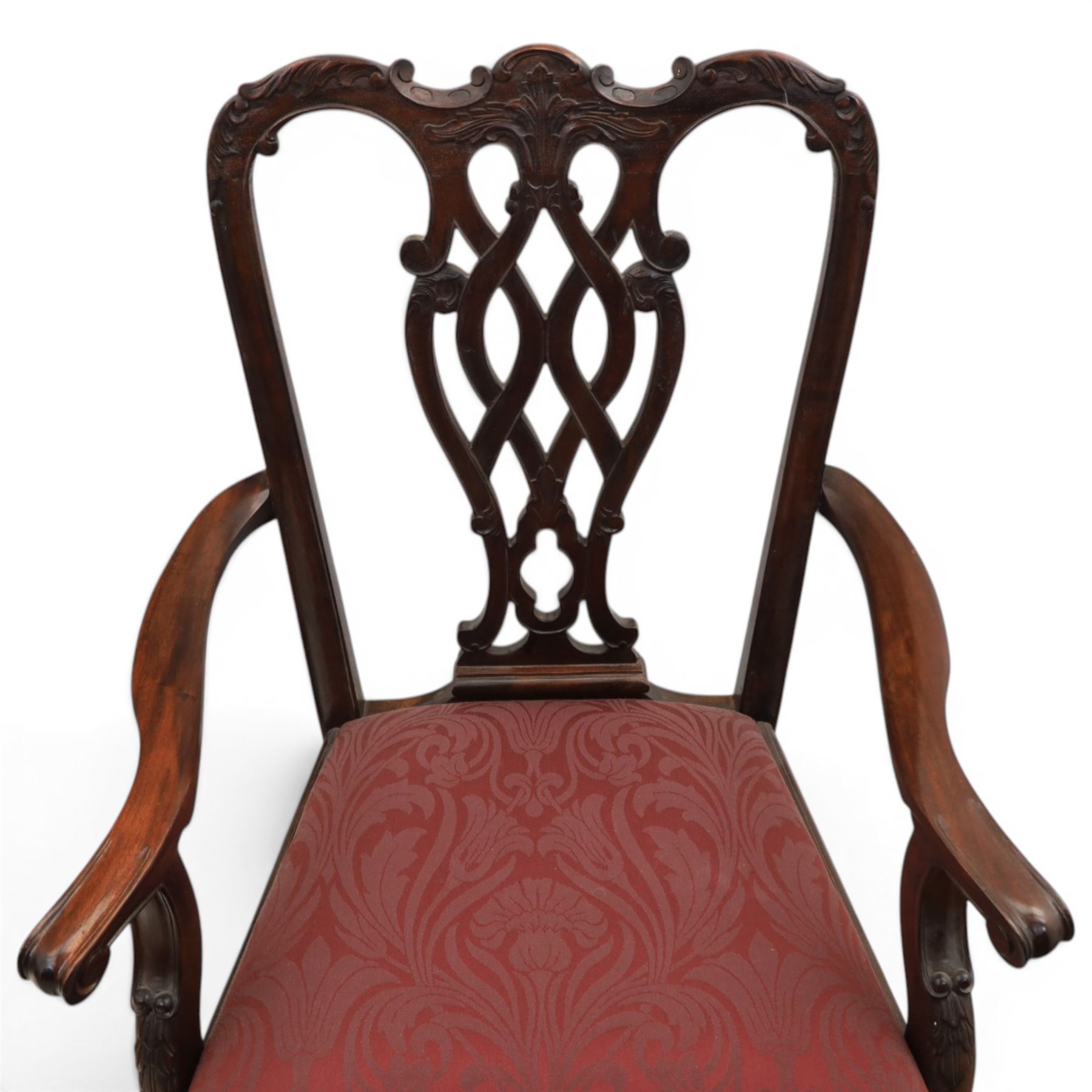 Chippendale design set of ten (8+2) mahogany dining chairs, serpentine cresting rails with carved detail over pierced ribbon-tied splats, red damask upholstered drop-in seats, on cabriole supports with acanthus carved knees and claw and ball feet