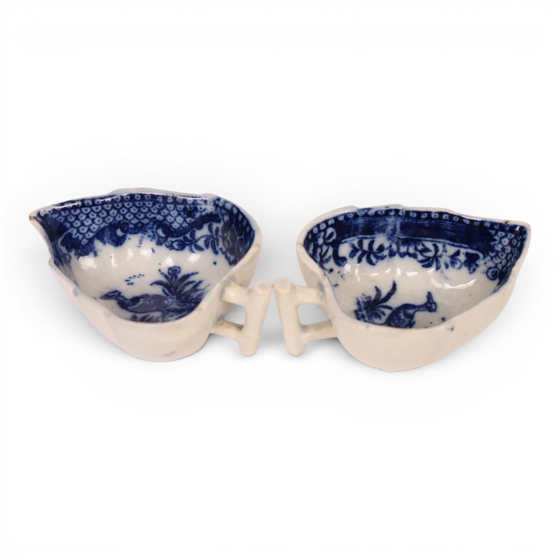 Pair of 18th century Derby blue and white leaf-shaped butter boats with stalk handles, internally decorated with a bird with in a foliage boarder, H3cm 