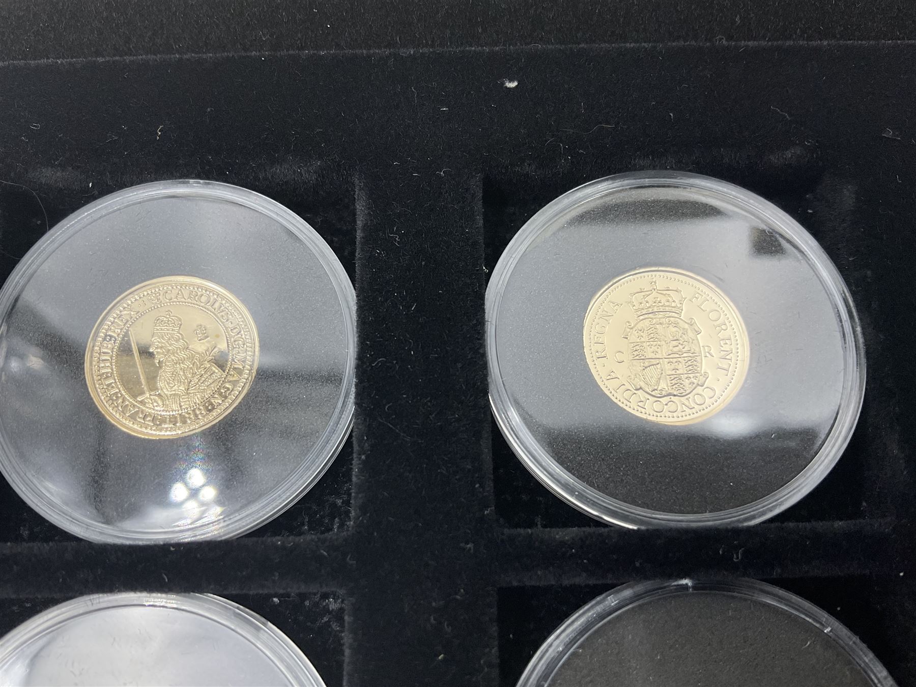 Sixteen hallmarked 9ct gold replica coins from 'The Historic Coins Of Great Britain Museum Gold Collection', housed in a Westminster display case, overall weight approximately 51.3 grams