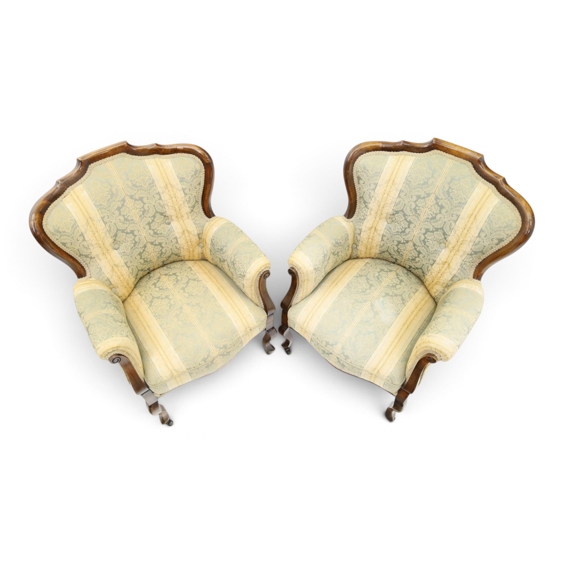 Edwardian mahogany three-piece salon suite, comprising settee and two armchairs, shaped frames with upholstered backs, scrolled arm supports and serpentine seat rails, upholstered in striped floral damask fabric, on cabriole supports with castors (Armchairs: H 96cm, W 70cm, D 68cm)
