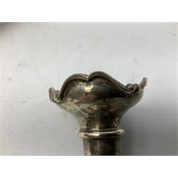 Four hallmarked silver trumpet vases, total weight 108g, upon silver plated stand with foliate decoration and bun feet