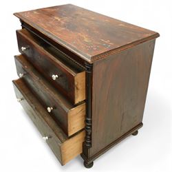 19th century painted pine chest of drawers, the rectangular top with moulded edge and painted floral decoration, above three drawers with later ceramic handles, with half turned column and reeded pilasters, upon turned compressed bun feet  