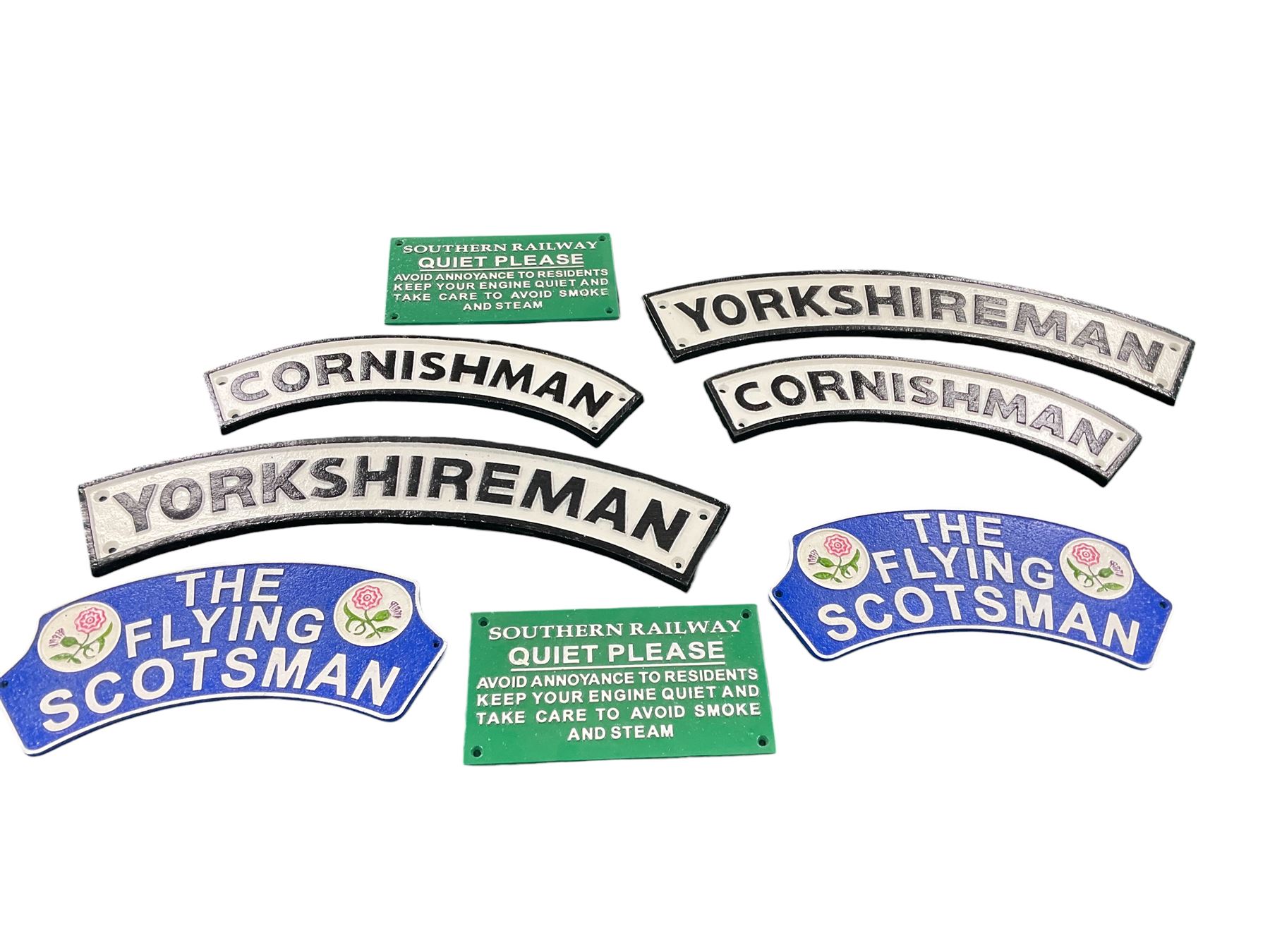 Collection of cast iron signs, including The Flying Scotsman, Yorkshireman, Cornishman etc 