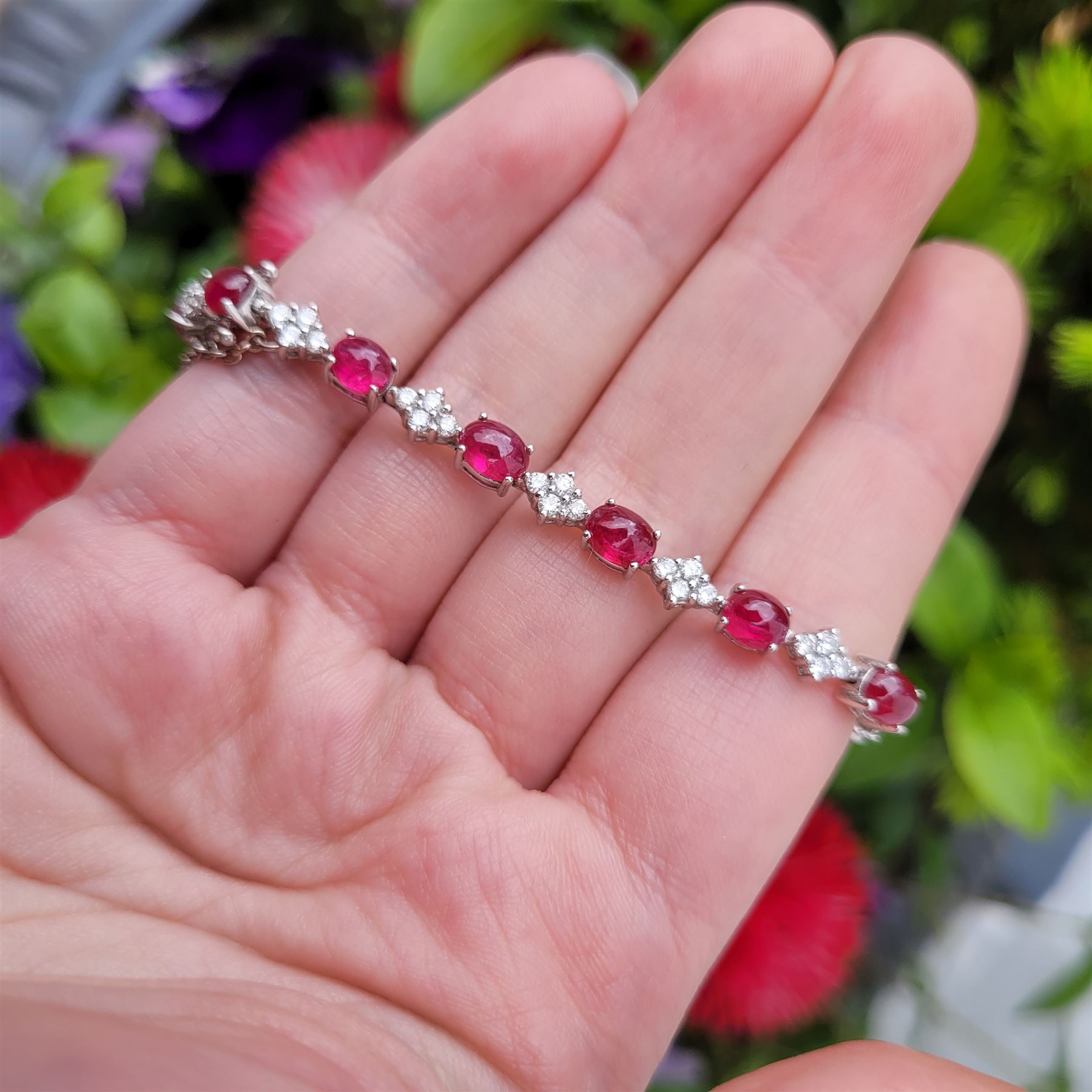 18ct white gold ruby and diamond bracelet, fifteen oval cabochon cut rubies, each spaced by four round brilliant cut diamonds, Sheffield 2009, total ruby weight 10.10 carat, total diamond weight approx 0.60 carat