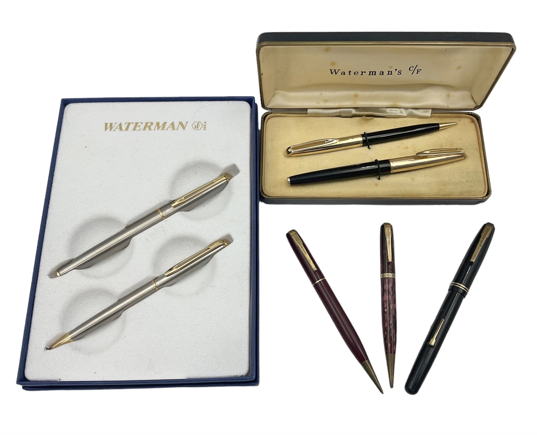 Group of Waterman pens and propelling pencils, to include a fountain pen, the black barrel with rolled gold cap and nib stamped 14ct, together with a matching propelling pencil, in box, together with a further fountain pen with gold nib stamped 14ct, stainless steel fountain pen and rollerball set in box, propelling pencil with maroon barrel etc, largest L13cm (7)