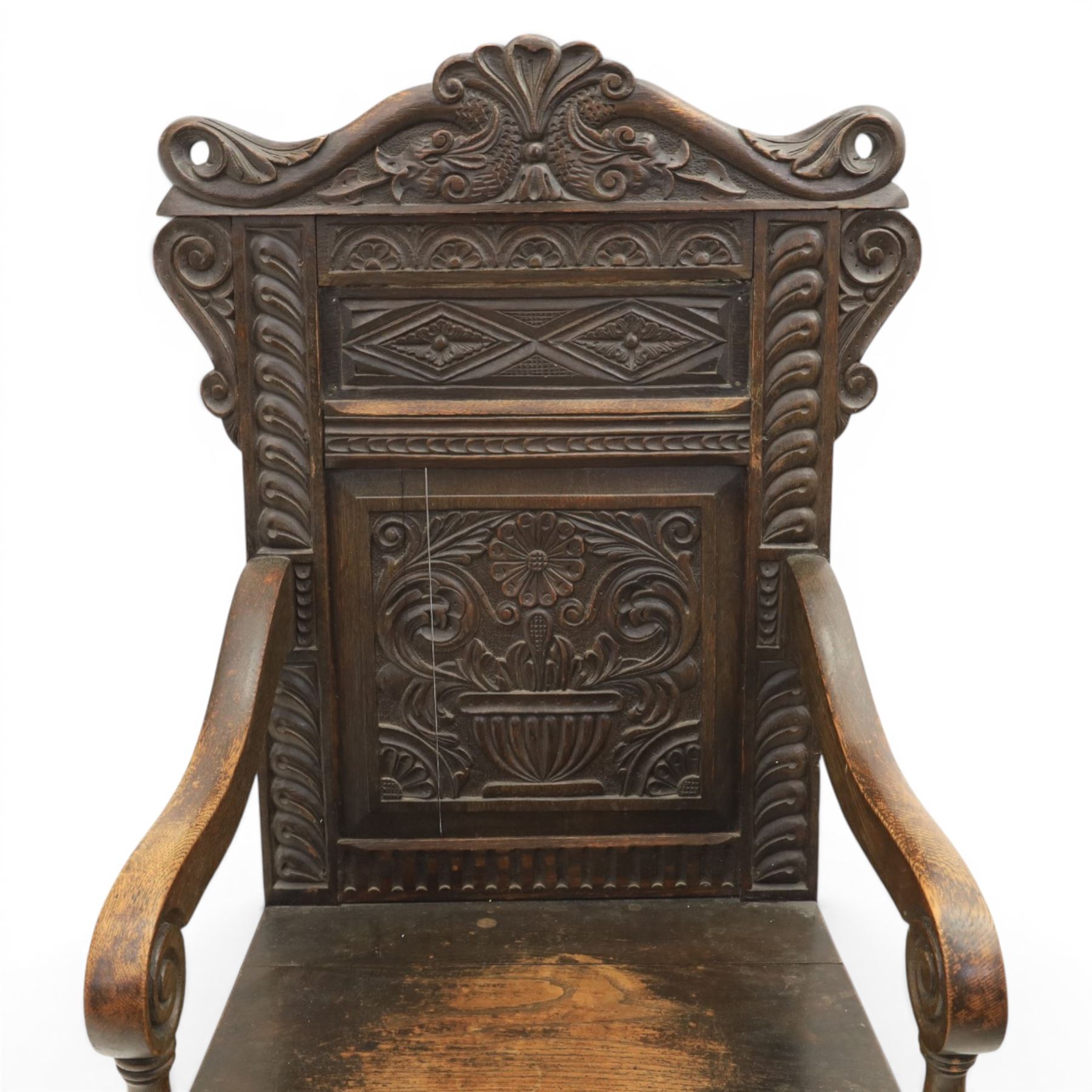 17th century style carved oak Wainscott chair, intricately carved back, united by a turned stretcher