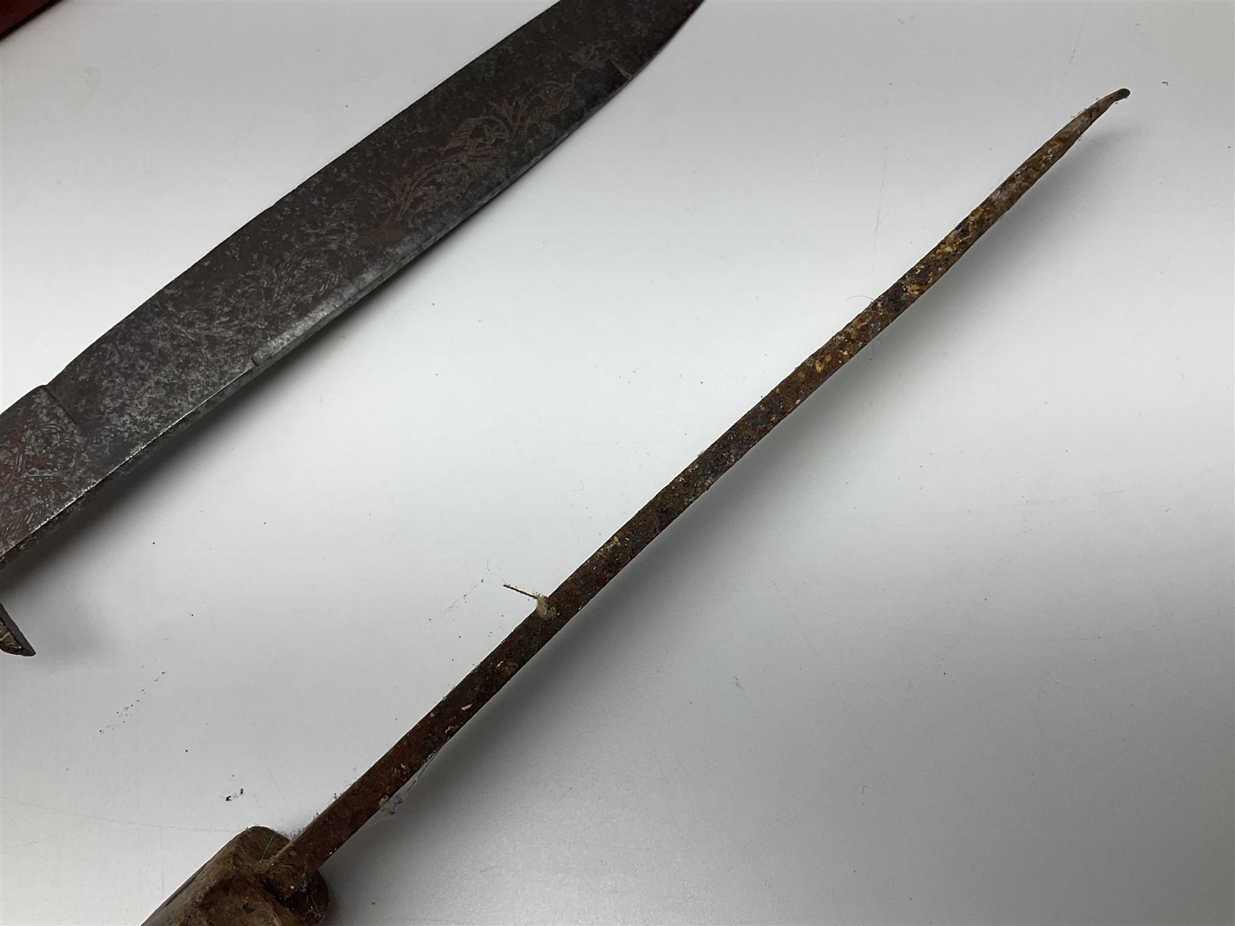 19th century continental folding knife with 15.5cm single edged blade, the pierced brass and iron handle with remains of horn grips L21.5cm overall closed; turned horn handled knife with foliate engraved blade; battlefield relic German 1884/98 knife bayonet; iron spear head; leather covered swagger stick; and two-piece gun cleaning rod