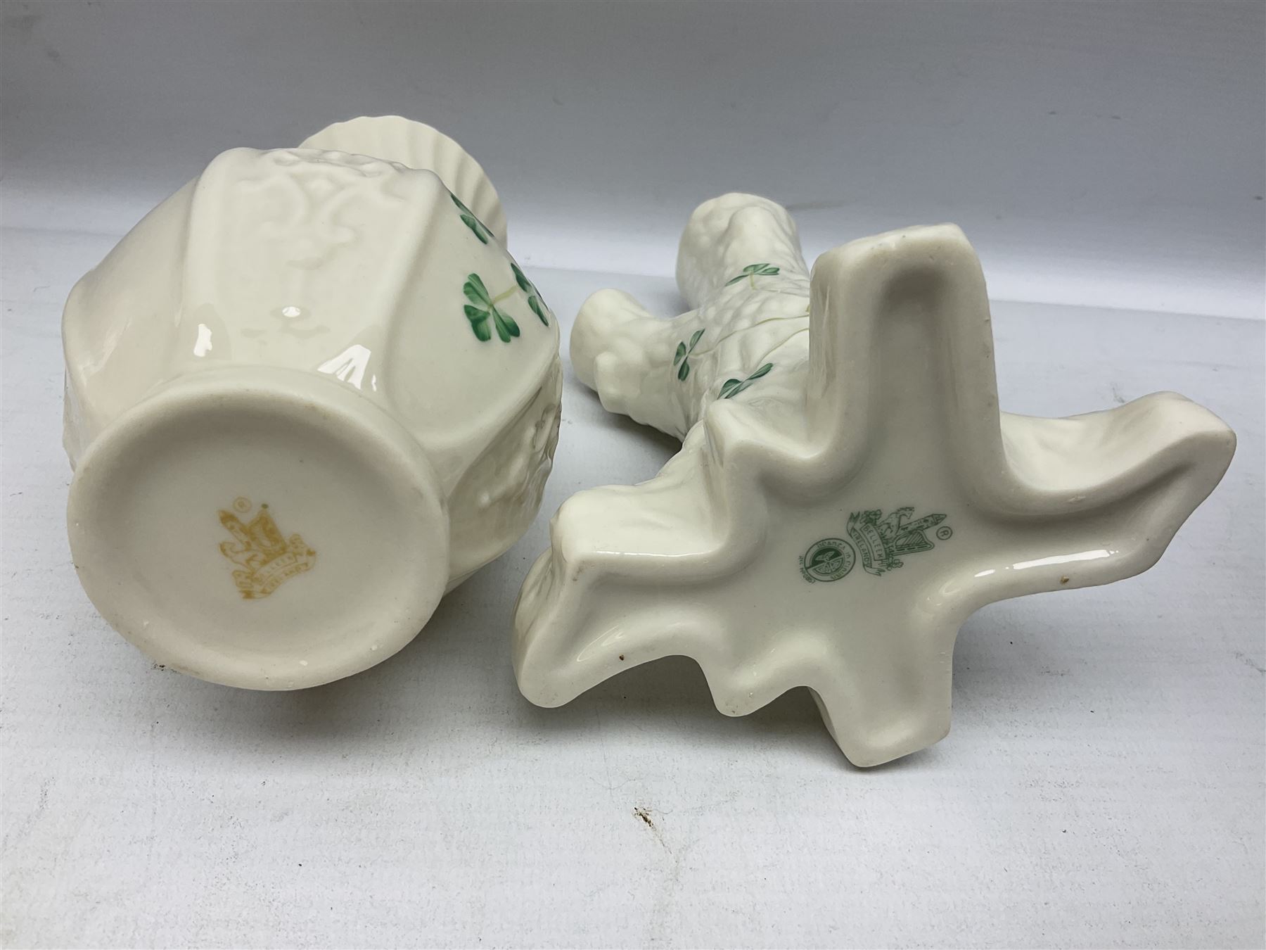 Five late 19th/early 20th century and later Belleek vases, comprising pair of Lotus Blossom examples, shamrock tree trunk vase, twin handled shamrock vase and a baluster form vase decorated with applied roses, all with printed marks beneath, tallest H16cm