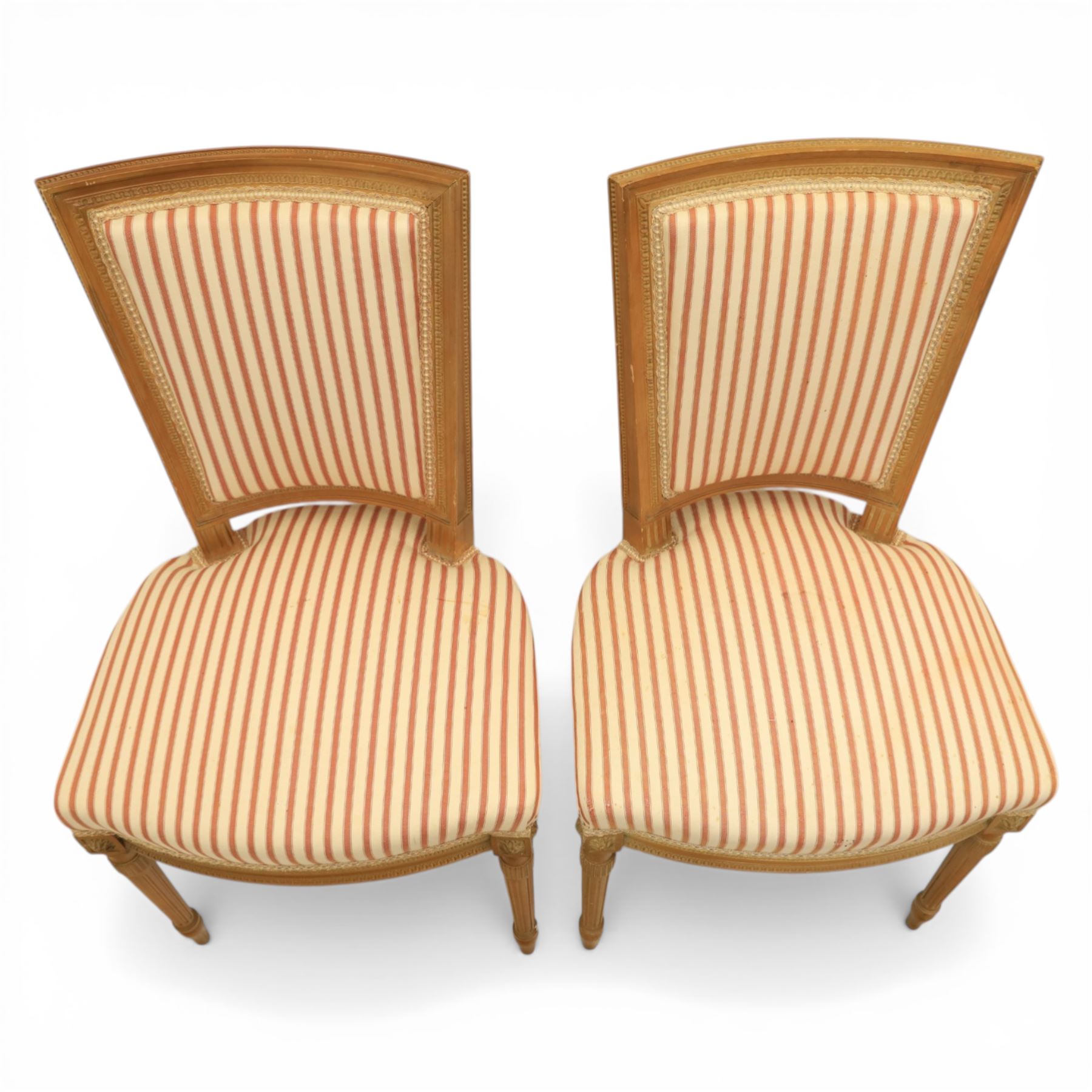 20th century Louis XVI style beech salon suite, comprising settee and four chairs, the settee with shaped rectangular back and upholstered arms over a shaped seat, the chairs with rectangular backs and overstuffed seats, each upholstered in striped fabric with close-nailed borders, upon fluted tapering supports headed by carved paterae, terminating in toupie feet, chairs H89cm W47cm