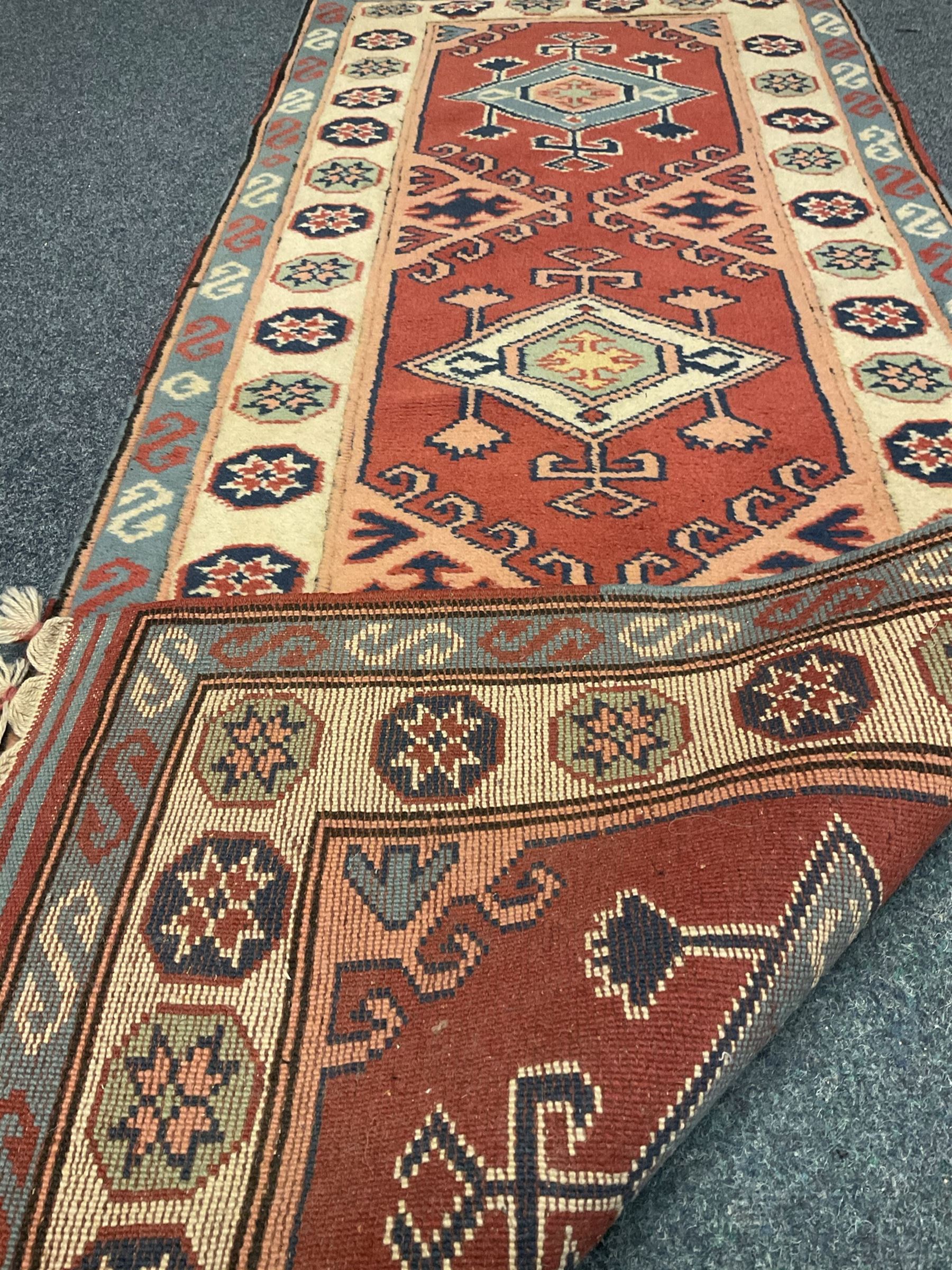 Turkish style runner rug, triple medallion surrounded by red field