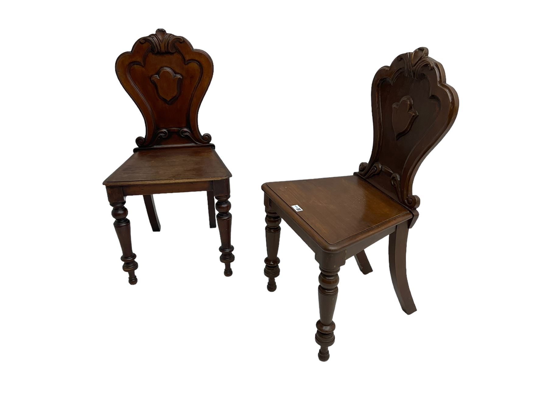 Pair of Victorian mahogany hall chairs, shaped moulded back carved with cartouche, moulded seat on turned front supports