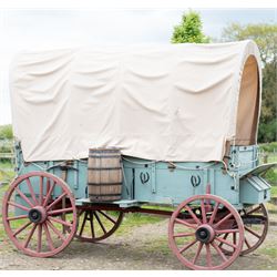 Western Covered Chuck Wagon

A large four wheeled covered wagon of timber construction, painted pale green with red painted wooden spoked wheels and a cream canvas tilt over an arched frame. The wagon has a traditional box body with covered rear compartment, front driving position, underbody turntable steering and iron fittings throughout. Fitted with external equipment details including a side mounted barrel, lidded storage chest, rope tie downs, horseshoe fittings and rear storage box.

Features

• Pale green painted timber body
• Cream canvas tilt over arched frame
• Covered rear compartment
• Front driving position
• Side mounted barrel
• External lidded storage chest
• Rear storage box
• Wooden spoked wheels
• Iron tyres
• Underbody turntable steering
• Rope tie downs
• Horseshoe fittings
• Iron hardware and brackets
• Brass restoration plaque to rear

Dimensions:
Overall length: 335 cm
Width: 170 cm
Height: 275 cm

Wheel Diameters:
Front wheels: 92 cm
Rear wheels: 112 cm

Seating:
Driver: 1
Passenger: Rear covered compartment