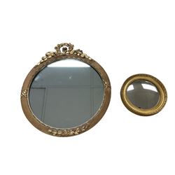 Early 20th century circular wall mirror in giltwood frame with gesso laurel wreath pediment dia.41cm; small convex wall mirror in gilt frame dia.19cm