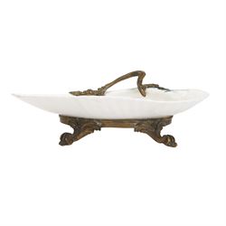 18th century porcelain dish, attributed to Chantilly, circa 1740-1750, with later ormolu mounted handle and feet, the dish of moulded shell form, painted in the Kakiemon pallet with an exotic bird and grasshopper amidst flowers and foliage, with foliate ormolu handle, and upon three scrolling foliate feet, possible obscure Chantilly mark beneath, including handle H10cm W31cm

A letter from the Ashmolean Museum accompanied the dish when it entered the current vendor's family collection. In the letter, Dr. Impey noted that the painting is European, possibly Dutch. The general consensus was that the shell dates to the 18th century, with the ormolu mounts likely added in the 19th century. However, the factory of origin remained unidentified. The letter was signed by Ian Lowe in 1974. Further consultation at the time with four members of staff at the Victoria and Albert Museum yielded differing opinions, with suggestions including Chantilly and Bow. The piece has been attributed to Chantilly partly due to what appears to be a partially obliterated horn motif beneath.