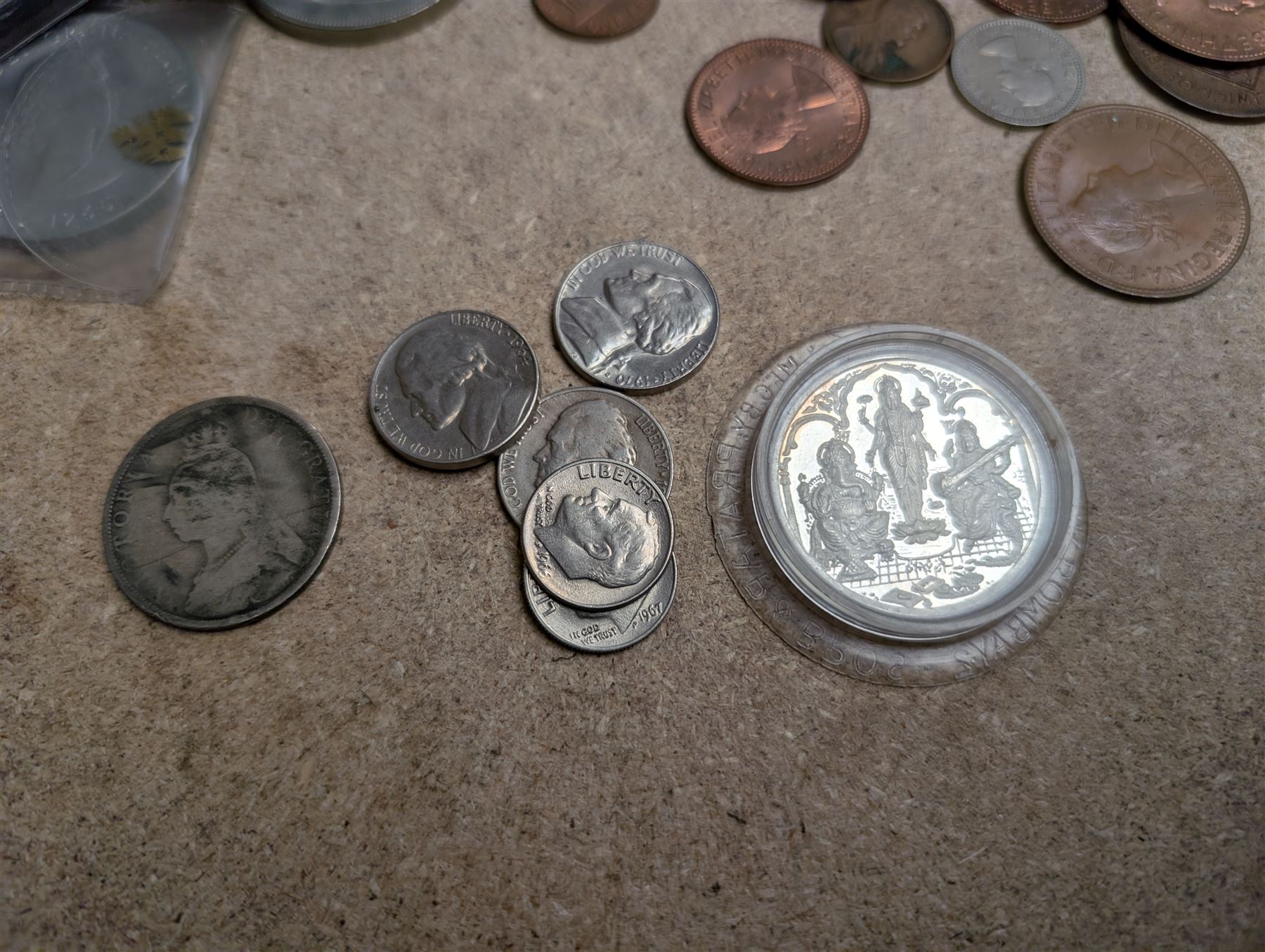 Collection of Great British and World coins, including 0.997 silver Laxmi Ganesh Krishiiamahavir Ambajishrinathji coin, American coins, commemorative coins, etc together with a silver fob medal, two Siam silver tie clips and a silver pen knife inscribed 1917